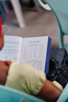 Individual reading a book on 'Contenido' in a chair at Matanzas, Cuba.